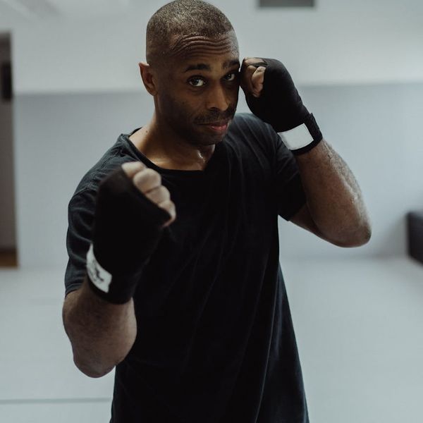 A man looking focused and determined during a workout session.